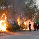 A file photo is shown of trees being set ablaze at Islamabad amidst anti-governmental riots.