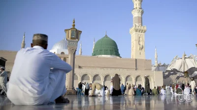 A file photo shows an individual sitting at The Prophet's Mosque in Medina.