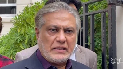 Former finance minister Ishaq Dar is shown addressing media in London.