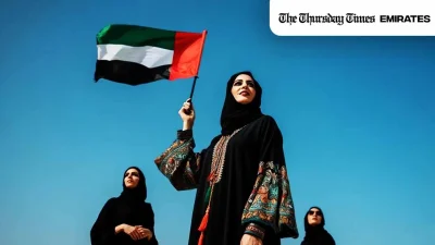 A file photo is shown of a woman holding the UAE's flag. — FILE