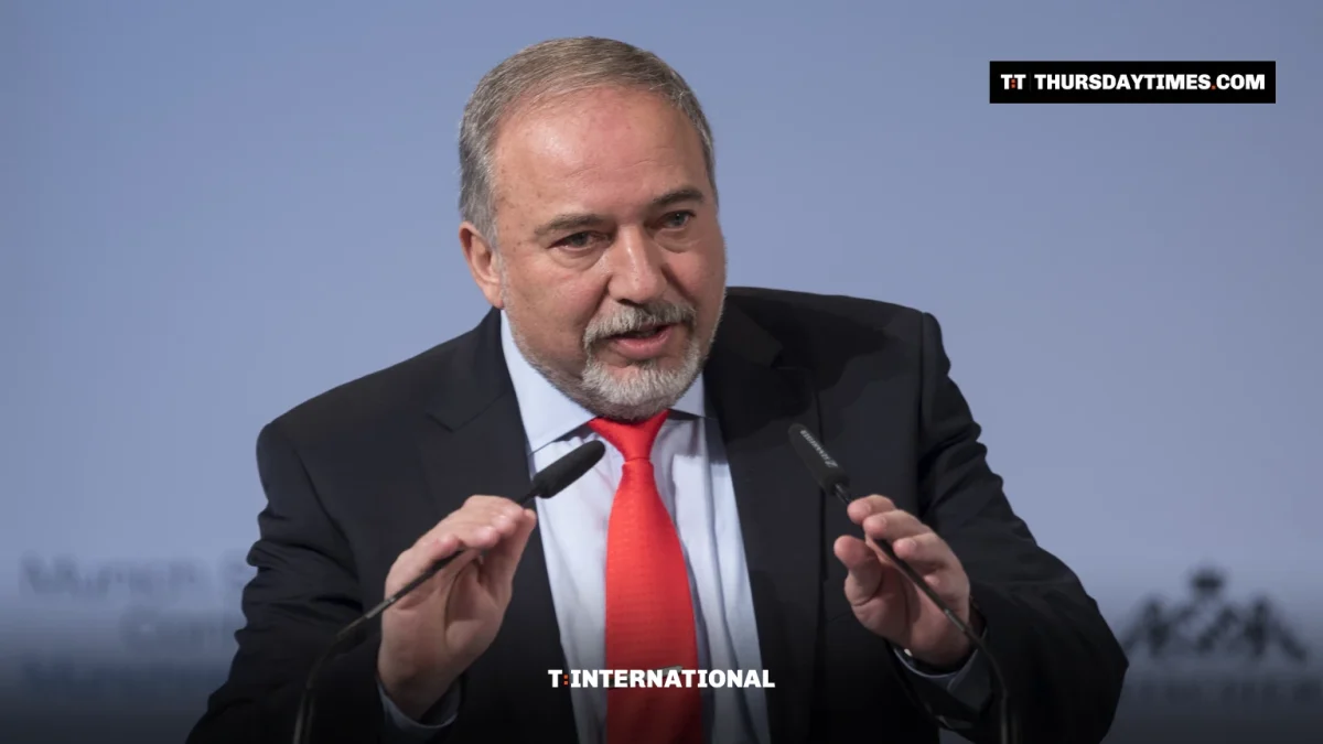 Avigdor Lieberman gestures while speaking at a lectern