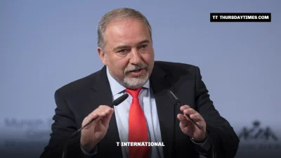 Avigdor Lieberman gestures while speaking at a lectern