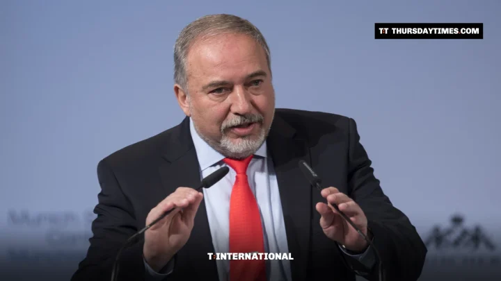 Avigdor Lieberman gestures while speaking at a lectern