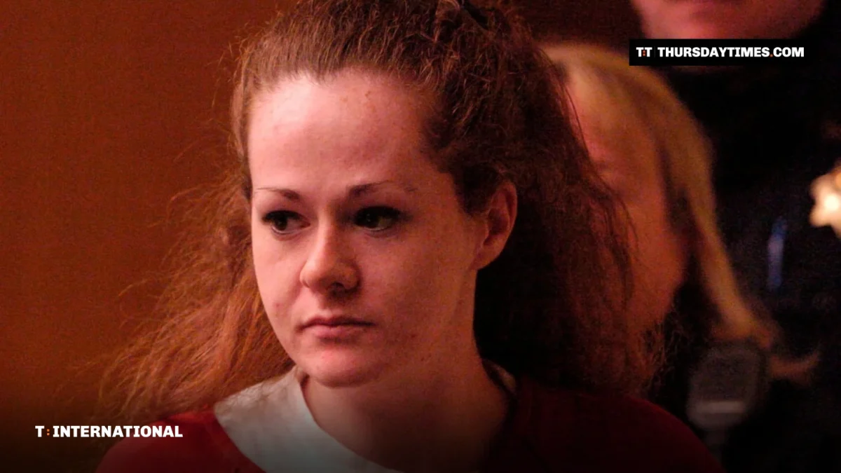 Christa Pike in a red prison uniform entering a courtroom
