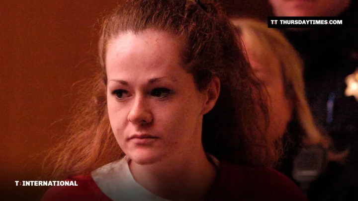 Christa Pike in a red prison uniform entering a courtroom