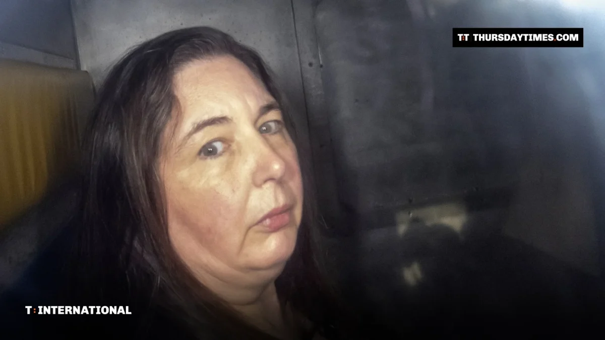 Erin Patterson looks out from the back of a prison transport vehicle in Melbourne