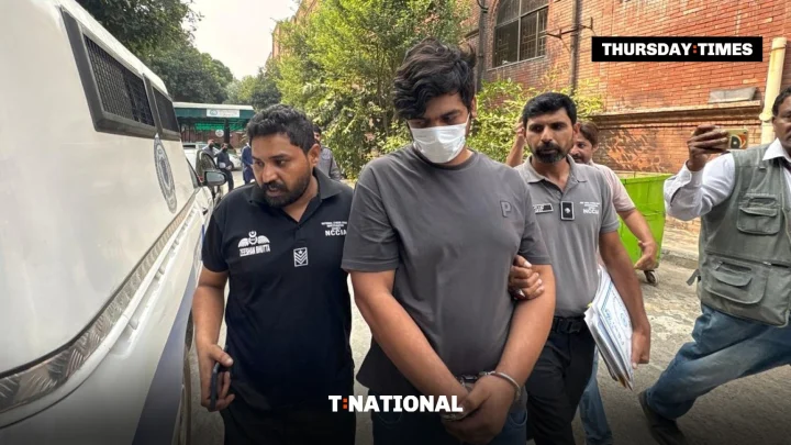 NCCIA officers escort Faheem Akram, accused of running a counterfeit US postage website, after his arrest. — FILE/THE THURSDAY TIMES