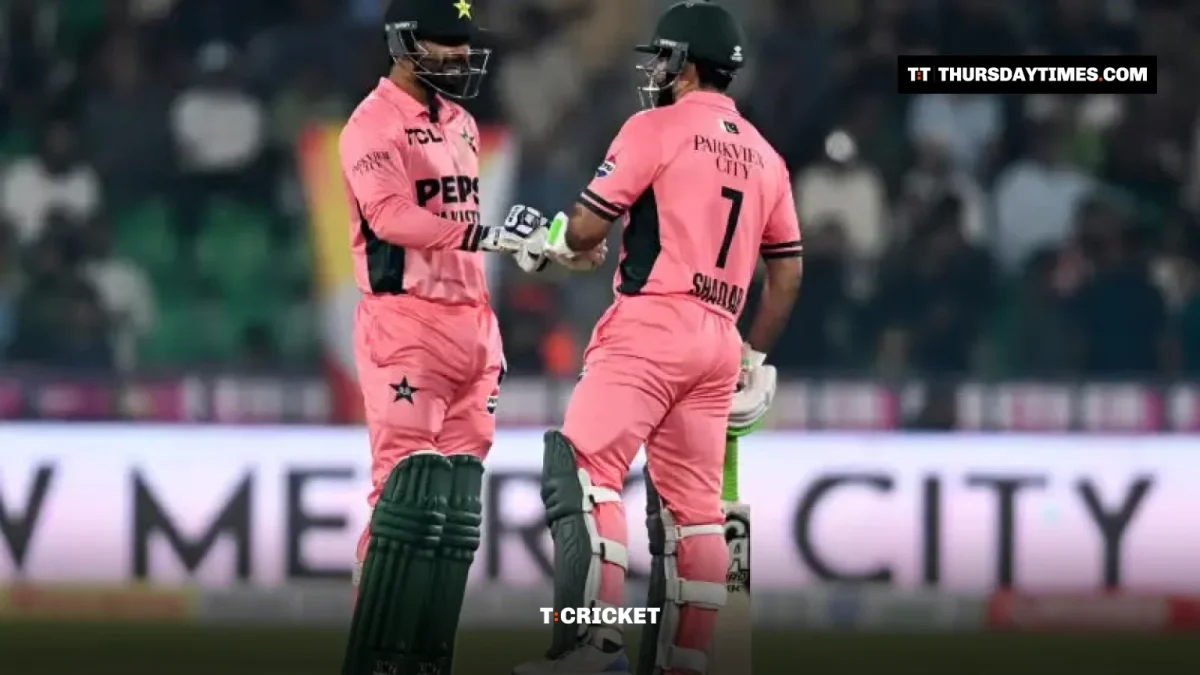 Haris Rauf and Shadab Khan in pink kits bump gloves in the middle at the Gaddafi Stadium