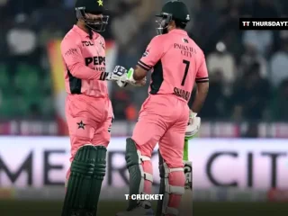 Haris Rauf and Shadab Khan in pink kits bump gloves in the middle at the Gaddafi Stadium