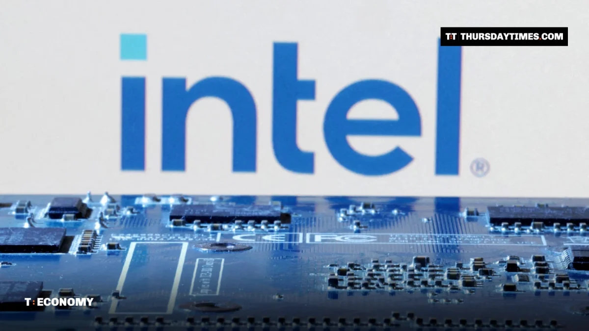 The Intel logo behind a computer circuit board