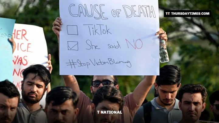 A protester holds a placard reading Cause of death: TikTok, She said no, Stop victim blaming