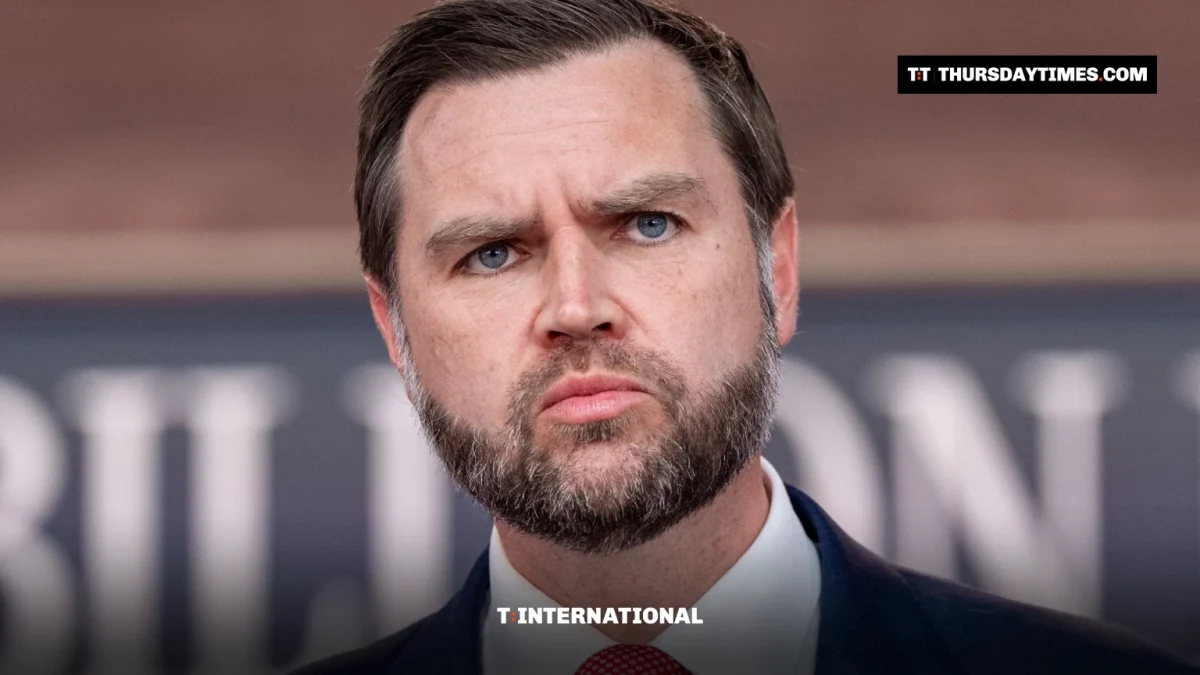 JD Vance looks ahead with a stern expression at a news conference