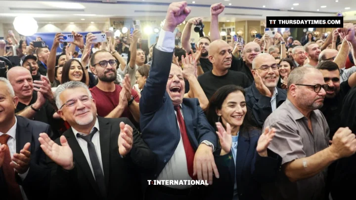 Yousef Jabareen raises a fist as Joint List members cheer exit poll results in Nazareth