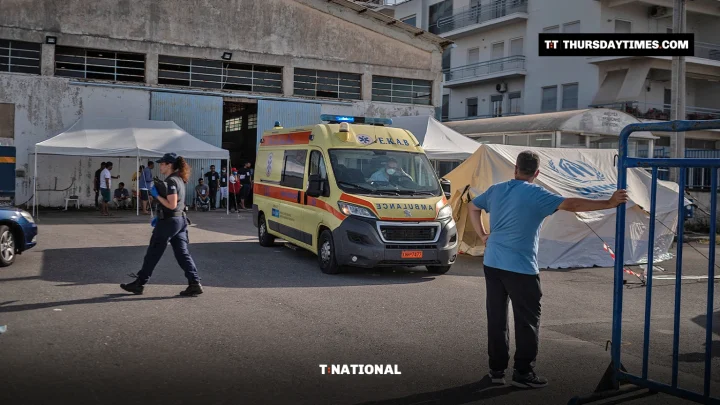 A yellow ambulance leaves a warehouse at Kalamata port where shipwreck survivors were sheltered