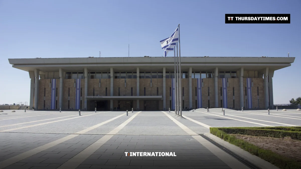 The Knesset building in Jerusalem with an Israeli flag in front