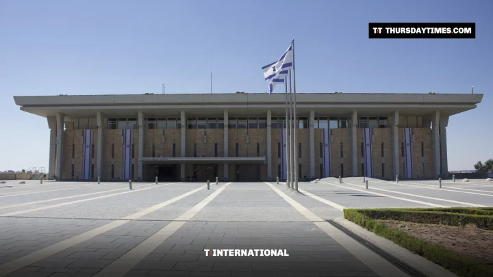The Knesset building in Jerusalem with an Israeli flag in front