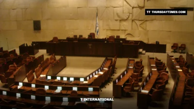 The empty plenum hall of the Knesset with rows of seats