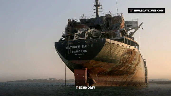 A burned-out bulk carrier sits stranded in shallow water off Qeshm Island