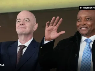 CAF president Patrice Motsepe and FIFA president Gianni Infantino wave from the stands