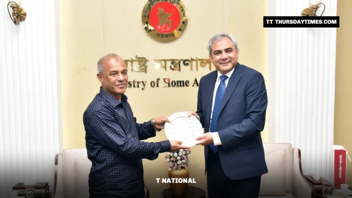 Bangladesh’s home minister hands a commemorative plate to Mohsin Naqvi in an office in Dhaka