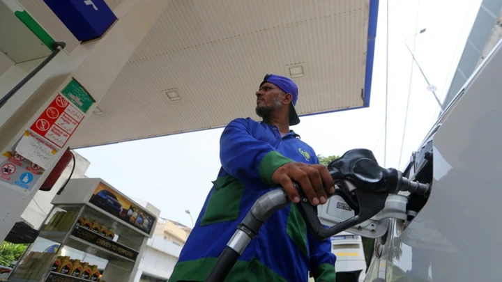 A worker refuels a vehicle at a fuel station in Peshawar, file photo. Photograph: EPA/Arshad Arbab
