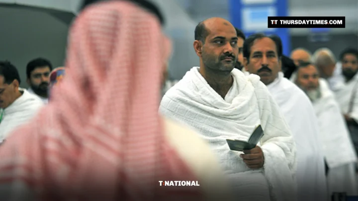 Pakistani pilgrims in white ihram garments queue at Jeddah airport holding passports