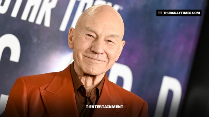 Patrick Stewart in a rust-coloured suit smiles in front of a Star Trek: Picard backdrop