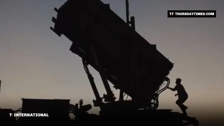 Silhouette of a soldier at a Patriot missile launcher at dusk