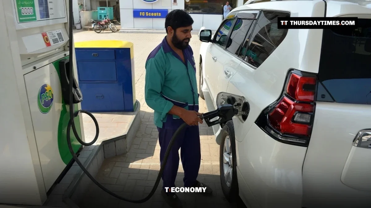 A petrol station worker fills a car in Peshawar
