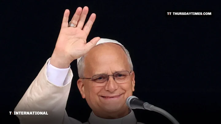 Pope Leo XIV waves from a window during the Angelus prayer
