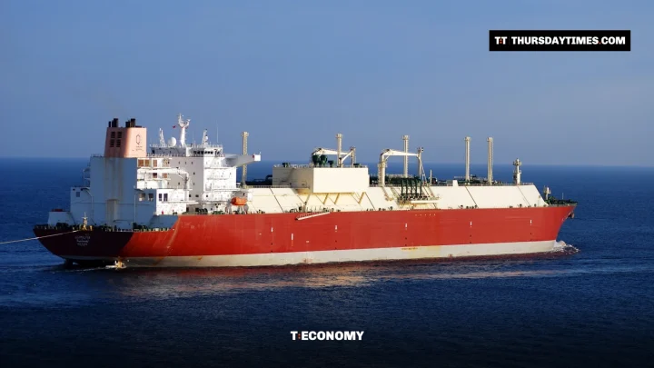 A red-hulled Qatari liquefied natural gas tanker sailing on open sea