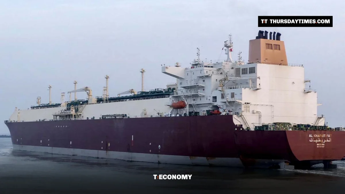A large maroon and white LNG tanker sails into Port Qasim