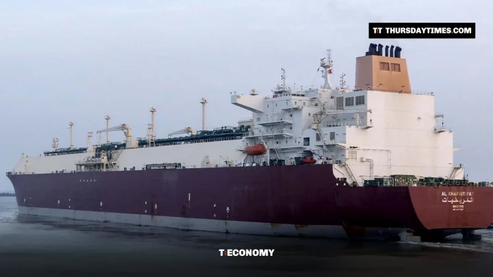 A large maroon and white LNG tanker sails into Port Qasim