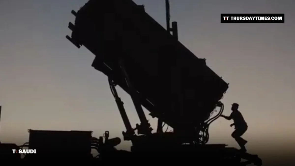 Silhouette of a soldier climbing onto a Patriot missile launcher at dusk