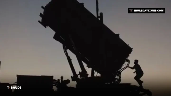 Silhouette of a soldier climbing onto a Patriot missile launcher at dusk