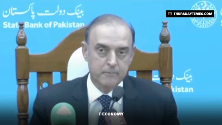 SBP Governor Jameel Ahmad seated before State Bank of Pakistan branding at a news conference