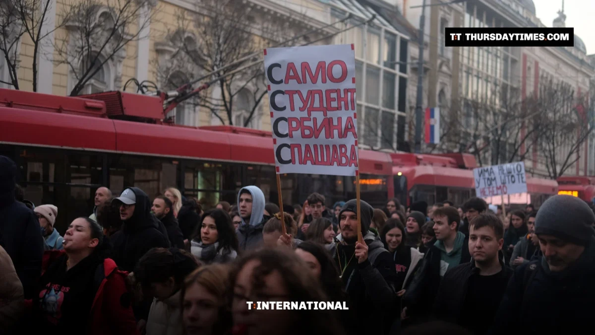 Students march through Belgrade holding a placard during a 2025 protest