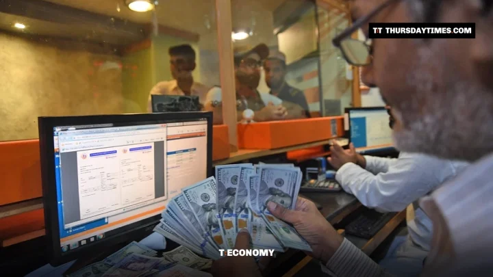 A currency dealer counts a fan of US dollar notes at an exchange counter in Karachi