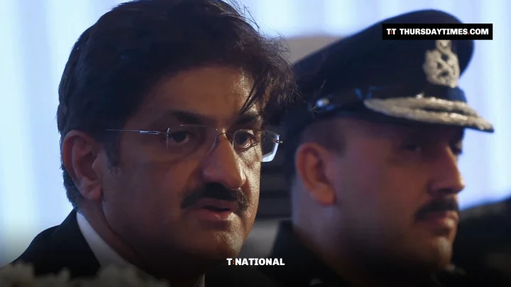 Sindh Chief Minister Murad Ali Shah speaks at a news conference beside a police officer