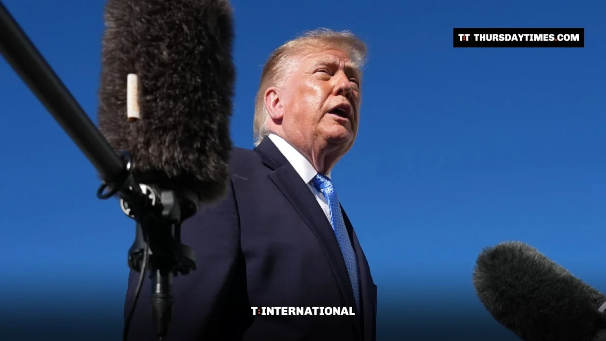 Donald Trump speaks to reporters in front of boom microphones