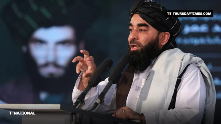 Zabihullah Mujahid speaking at a podium